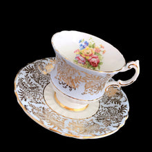 Load image into Gallery viewer, Vintage fine bone china blue teacup and saucer with colourful roses and gold gilt filigree and trim. Crafted by PARAGON, England. A lovely way to enjoy a cuppa tea!

In excellent condition, no chips, cracks or repairs. Single warrant stamp.

Measures 3 1/4 x 2 7/8 inches | Saucer measures 5 5/8 inches
