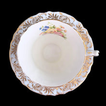 Load image into Gallery viewer, Vintage fine bone china blue teacup and saucer with colourful roses and gold gilt filigree and trim. Crafted by PARAGON, England. A lovely way to enjoy a cuppa tea!

In excellent condition, no chips, cracks or repairs. Single warrant stamp.

Measures 3 1/4 x 2 7/8 inches | Saucer measures 5 5/8 inches
