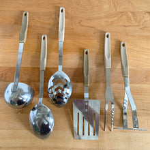 Load image into Gallery viewer, Overhead view of back side of vintage 6-piece stainless steel kitchen utensil set with cream melamine handles, Japan 1950s
