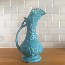 Load image into Gallery viewer, Vintage Art Deco gloss blue Rustic Line handled pitcher vase with embossed grapevines. Crafted by McCoy Pottery, 1945. This rare piece is must for any McCoy art pottery collector!

In excellent vintage condition, no chips/cracks/repairs. Maker&#39;s mark.

Measures 5 1/4 x 9 inches
