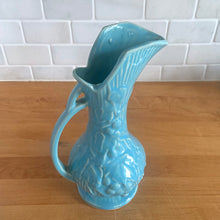 Load image into Gallery viewer, Vintage Art Deco gloss blue Rustic Line handled pitcher vase with embossed grapevines. Crafted by McCoy Pottery, 1945. This rare piece is must for any McCoy art pottery collector!

In excellent vintage condition, no chips/cracks/repairs. Maker&#39;s mark.

Measures 5 1/4 x 9 inches
