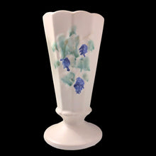Load image into Gallery viewer, Creamware is a favourite of ours. This sweet Art Deco paneled trumpet shape art pottery footed vase features embossed blue grapes and green leaves. Crafted by McCoy, USA, circa 1940s. Perfect for display or a lovely floral bouquet. In excellent condition, free from chips/cracks/repairs. Measures 3 1/2 x 7 inches
