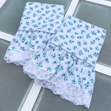 Load image into Gallery viewer, This is a gorgeous set of vintage standard sized pillowcases featuring a sweet pattern of blue and green florals, bordered by blue piping and a ruffled edge finished with delicate white lace. Produced by Croscill Inc., USA, circa 1980s. A romantic country style to your home decor or repurpose the fabric for crafts or clothing! In new condition. The colours are vibrant and the fabric crisp. Measures 20 1/2 x 31 inches
