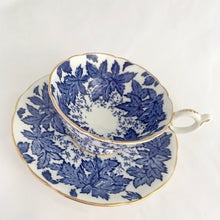 Load image into Gallery viewer, Antique bone china teacup and saucer with a subtle scalloped edge with transferware pattern of cobalt blue maple leaves, French loop handle with thumb rest, and edges trimmed with gold gilt. Crafted by Coalport, England, circa 1920s. In excellent condition, free from chips, cracks and repairs. Marked &quot;Crafted by Coalport Bone China, England, AD1750&quot; with the pattern number in gold. Teacup measures 4 x 2 1/4 inches | Saucer measures 5 ½ inches
