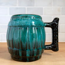 Load image into Gallery viewer, Side view detail of the barrel mug in green drip glaze, showing the handle's full textured profile
