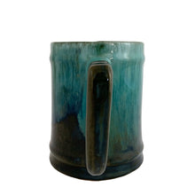 Load image into Gallery viewer, Handle view of Blue Mountain Pottery green drip glaze mug showing full teal drip glaze pattern across cylindrical body and handle attachment

