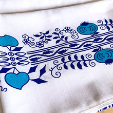 Load image into Gallery viewer, This exquisite Vintage &quot;Blue Onion&quot; Patterned White Linen Tablecloth is adorned with delicate blue teal florals, hearts, and onions, creating a charming and unique design. Crafted from high-quality linen, this tablecloth adds a touch of elegance to any dining experience. Perfect for&nbsp;casual and&nbsp;special occasions!  In excellent condition, free from tears. Tiny pale stain.  Measures 46 1/2 x 56 inches

