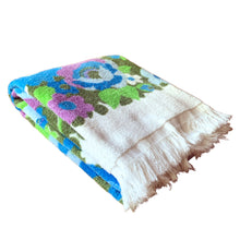 Load image into Gallery viewer, Vintage white cotton terrycloth bath towel featuring blue, purple and green florals with fringed edge. 1970s. A lovely addition to your bath collection.

In as found used condition with staining at one end, see photos.

Measures 24 x 44 inches
