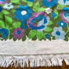 Load image into Gallery viewer, Vintage white cotton terrycloth bath towel featuring blue, purple and green florals with fringed edge. 1970s. A lovely addition to your bath collection.

In as found used condition with staining at one end, see photos.

Measures 24 x 44 inches

