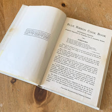 Load image into Gallery viewer, This vintage hardcover Blue Ribbon and Pure Gold Cook Book – For Everyday Use in Canadian Homes is a jam-packed collection of recipes using Pure Gold Manufacturing Company products. 158 pages filled with cooking techniques, hundreds of recipes and extensive index. 19th Edition, 1946 and retains one of the four original mail-in coupons at the front of the book. There are six pages of vibrant colour advertisements for Blue Ribbon and Pure Gold products.
