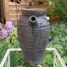Load image into Gallery viewer, Rare vintage blue stoneware batter jug or pitcher decorated with panels of a figure playing a lyre against a stippled ground with decorative details. Crafted by Robinson Ransbottom Pottery Co., USA, 1920s.

In good used vintage condition, minor flea bites to the rim and foot. Normal age-related crazing. Unmarked.

Measures 9 x 10 1/2 inches (incl. spout/handle)
