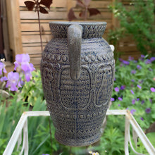 Load image into Gallery viewer, Rare vintage blue stoneware batter jug or pitcher decorated with panels of a figure playing a lyre against a stippled ground with decorative details. Crafted by Robinson Ransbottom Pottery Co., USA, 1920s.

In good used vintage condition, minor flea bites to the rim and foot. Normal age-related crazing. Unmarked.

Measures 9 x 10 1/2 inches (incl. spout/handle)

