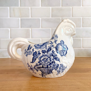 Vintage figural chicken ironstone creamer featuring blue transferware florals. Crafted by Crown Devon Fieldings, England, 1930s. Add a touch of cottage charm to your tableware with this adorable creamer.

In excellent condition, no chips/cracks/repairs, crazing and minor staining present. Marked Crown Devon Fieldings Staffordshire England Acid Resistant.

Measures 5 1/4 x 3 x 3 3/4 inches