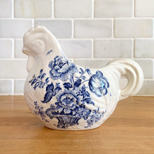 Load image into Gallery viewer, Vintage figural chicken ironstone creamer featuring blue transferware florals. Crafted by Crown Devon Fieldings, England, 1930s. Add a touch of cottage charm to your tableware with this adorable creamer.

In excellent condition, no chips/cracks/repairs, crazing and minor staining present. Marked Crown Devon Fieldings Staffordshire England Acid Resistant.

Measures 5 1/4 x 3 x 3 3/4 inches
