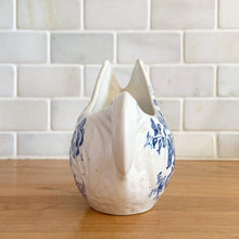 Load image into Gallery viewer, Vintage figural chicken ironstone creamer featuring blue transferware florals. Crafted by Crown Devon Fieldings, England, 1930s. Add a touch of cottage charm to your tableware with this adorable creamer.

In excellent condition, no chips/cracks/repairs, crazing and minor staining present. Marked Crown Devon Fieldings Staffordshire England Acid Resistant.

Measures 5 1/4 x 3 x 3 3/4 inches
