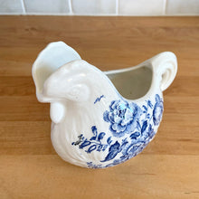 Load image into Gallery viewer, Vintage figural chicken ironstone creamer featuring blue transferware florals. Crafted by Crown Devon Fieldings, England, 1930s. Add a touch of cottage charm to your tableware with this adorable creamer.

In excellent condition, no chips/cracks/repairs, crazing and minor staining present. Marked Crown Devon Fieldings Staffordshire England Acid Resistant.

Measures 5 1/4 x 3 x 3 3/4 inches
