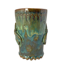 Load image into Gallery viewer, Vintage watery blue, green, ochre high fired drip glaze studio pottery mug featuring applied and debossed dragonflies with sculpted handle and scalloped base. Signed AA. This gorgeous one-of-a-kind handmade vessel is perfect for any hot beverage.

In excellent condition, no chips, cracks or repairs. Typical manufacturing glaze bubbles.

Measures 3 7/8 x 5 1/2 inches (5 7/8" incl. handle)

Capacity 16oz
