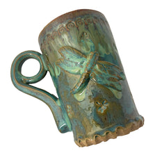 Load image into Gallery viewer, Vintage watery blue, green, ochre high fired drip glaze studio pottery mug featuring applied and debossed dragonflies with sculpted handle and scalloped base. Signed AA. This gorgeous one-of-a-kind handmade vessel is perfect for any hot beverage.

In excellent condition, no chips, cracks or repairs. Typical manufacturing glaze bubbles.

Measures 3 7/8 x 5 1/2 inches (5 7/8" incl. handle)

Capacity 16oz
