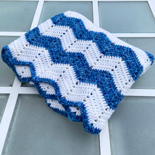 Load image into Gallery viewer, Beautifully crafted vintage handmade crochet blanket throw features a blue and white zigzag chevron ripple design. This super cozy throw is perfect for curling up in front of the fire with a good book or watching a movie.  In excellent condition.  Measures 56 x 64 inches
