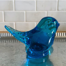 Load image into Gallery viewer, Lovely vintage hand blown art glass bluebird featuring a platform to hold a tea light or votive candle holder. Designed by artisan Leo Ward, his signature is on the bottom with the year 1987. Mr. Ward was the creator of Arkansas&#39; Bluebird of Happiness and owner of Terra Studios in Arkansas. He crafted these much beloved bluebirds until his death at 89.  In excellent condition, free from chips or cracks. Measures 4 x 3 3/4 x 2 1/2 inches
