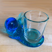 Load image into Gallery viewer, Lovely vintage hand blown art glass bluebird featuring a platform to hold a tea light or votive candle holder. Designed by artisan Leo Ward, his signature is on the bottom with the year 1987. Mr. Ward was the creator of Arkansas&#39; Bluebird of Happiness and owner of Terra Studios in Arkansas. He crafted these much beloved bluebirds until his death at 89.  In excellent condition, free from chips or cracks. Measures 4 x 3 3/4 x 2 1/2 inches
