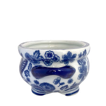 Load image into Gallery viewer, Opposite side view of Bombay Company blue and white chinoiserie round cachepot, showing the open interior, cobalt rim, and floral chinoiserie pattern wrapping the exterior body and handle
