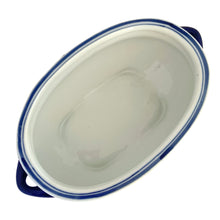 Load image into Gallery viewer, Overhead view of Bombay Company blue and white chinoiserie oval jardiniere showing the smooth white glazed bowl interior and cobalt blue rim stripe with cobalt handles
