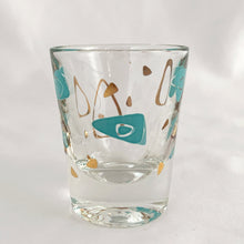 Load image into Gallery viewer, Vintage mid-century design in this turquoise and 22kt gold Boomerang Amoeba shot glass. Crafted by Federal Glass, USA, 1960s. A fabulous example of atomic style, this wee cocktail glass will amp up any bar cart and makes a fabulous addition to any barware collection.

In excellent condition, no chips, minor wear.

Measures 2 x 2 1/4 inches

Capacity 1 oz
