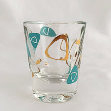 Load image into Gallery viewer, Vintage mid-century design in this turquoise and 22kt gold Boomerang Amoeba shot glass. Crafted by Federal Glass, USA, 1960s. A fabulous example of atomic style, this wee cocktail glass will amp up any bar cart and makes a fabulous addition to any barware collection.

In excellent condition, no chips, minor wear.

Measures 2 x 2 1/4 inches

Capacity 1 oz
