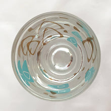 Load image into Gallery viewer, Vintage mid-century design in this turquoise and 22kt gold Boomerang Amoeba shot glass. Crafted by Federal Glass, USA, 1960s. A fabulous example of atomic style, this wee cocktail glass will amp up any bar cart and makes a fabulous addition to any barware collection.

In excellent condition, no chips, minor wear.

Measures 2 x 2 1/4 inches

Capacity 1 oz
