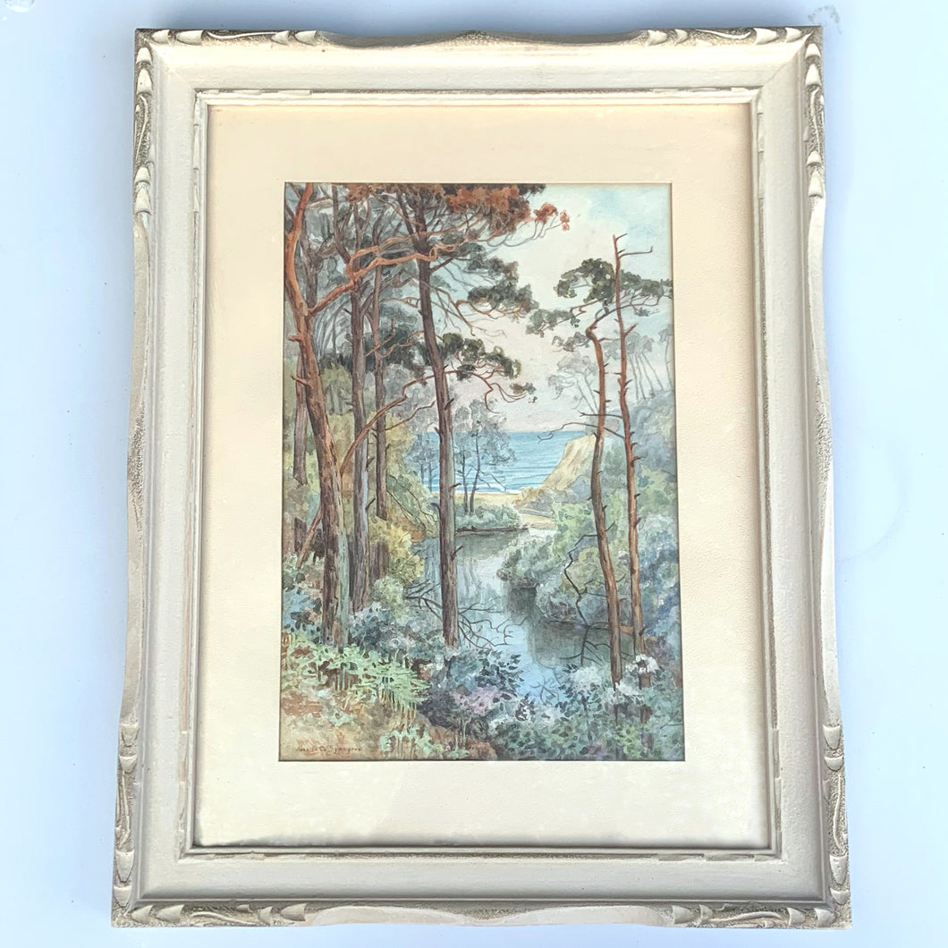 Vintage watercolour painting of Branksome Chine Beach in Bournemouth England. Professionally framed in wood with matte. Signed by the artist, Juanita O. (Lebarre) Symington (1904-1980), circa 1950s. Symington added a hand written description of the painting on the back of the painting describing the picturesque scene and that this was the location where the smuggler Gulliver amassed a fortune.  Artwork measures 8 1/4 x 12 1/4 inches  Wood frame measures 14 1/2 x 18 5/8 inches
