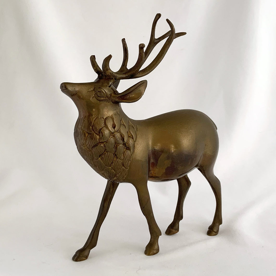 Vintage solid brass deer stag with antlers figurine. A wonderful piece to use for Christmas and holiday shelf, table or mantel decor.

In excellent condition with patina.

Measures 7 1/2 x 2 1/4 x 9 inches