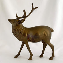 Load image into Gallery viewer, Vintage solid brass deer stag with antlers figurine. A wonderful piece to use for Christmas and holiday shelf, table or mantel decor.

In excellent condition with patina.

Measures 7 1/2 x 2 1/4 x 9 inches
