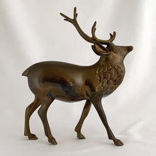 Load image into Gallery viewer, Vintage solid brass deer stag with antlers figurine. A wonderful piece to use for Christmas and holiday shelf, table or mantel decor.

In excellent condition with patina.

Measures 7 1/2 x 2 1/4 x 9 inches
