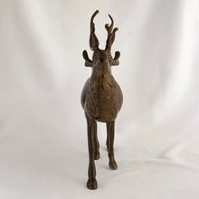 Load image into Gallery viewer, Vintage solid brass deer stag with antlers figurine. A wonderful piece to use for Christmas and holiday shelf, table or mantel decor.

In excellent condition with patina.

Measures 7 1/2 x 2 1/4 x 9 inches
