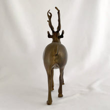 Load image into Gallery viewer, Vintage solid brass deer stag with antlers figurine. A wonderful piece to use for Christmas and holiday shelf, table or mantel decor.

In excellent condition with patina.

Measures 7 1/2 x 2 1/4 x 9 inches
