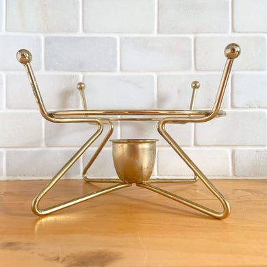 Vintage mid-century modern brass metal warming stand #468 features an atomic design with a holder for a votive candle. This stand fits a 2 quart Fire-King casserole dish., or could be used to keep a hot beverage carafe warm.  In excellent used vintage condition.  Measures 8 1/8 x 5 inches