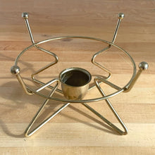 Load image into Gallery viewer, Vintage mid-century modern brass metal warming stand #468 features an atomic design with a holder for a votive candle. This stand fits a 2 quart Fire-King casserole dish., or could be used to keep a hot beverage carafe warm.  In excellent used vintage condition.  Measures 8 1/8 x 5 inches
