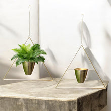 Load image into Gallery viewer, This is the real deal! Fabulous vintage triangular shaped brass metal wire plant hanger with fixed planter pot. They can be hung individually, in tandem or aligned for that added wow factor! Crafted in France, 1960s. A sweet way to add mid-century bohemian style to your home decor and the perfect gift for any plant lover!

In good vintage condition with original sticker. Age appropriate wear to the pot.

Hanging frame measures 20 3/4 x 33 inches, pot measures 6 1/8 x 5 1/8 inches
