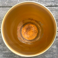 Load image into Gallery viewer, This is the real deal! Fabulous vintage triangular shaped brass metal wire plant hanger with fixed planter pot. They can be hung individually, in tandem or aligned for that added wow factor! Crafted in France, 1960s. A sweet way to add mid-century bohemian style to your home decor and the perfect gift for any plant lover!

In good vintage condition with original sticker. Age appropriate wear to the pot.

Hanging frame measures 20 3/4 x 33 inches, pot measures 6 1/8 x 5 1/8 inches

