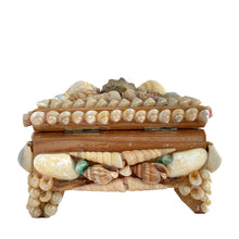 Load image into Gallery viewer, A charming mid-century artisan made trinket box handcrafted in Bremen, Germany, where maritime heritage runs deep despite the city's inland location. This piece exemplifies the golden age of shell art—a beloved souvenir tradition that flourished aboard luxury ocean liners like the SS Bremen and in European coastal gift shops. The wooden base is adorned with genuine shells, creating an authentic tactile surface that captures the romance of vintage travel. 
