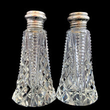Load image into Gallery viewer, Enhance your tablescape with these sparkling vintage brilliant fine cut crystal tower-shaped salt and peppers shakers topped with sterling silver lids inlaid with mother-of-pearl....stunning!

The crystal is in excellent condition, no chips. The sterling silver lids show age related wear. Marked Sterling 925 with hallmark.

Measures 2 x 4 1/2 inches

