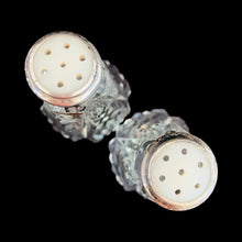 Load image into Gallery viewer, Enhance your tablescape with these sparkling vintage brilliant fine cut crystal tower-shaped salt and peppers shakers topped with sterling silver lids inlaid with mother-of-pearl....stunning!

The crystal is in excellent condition, no chips. The sterling silver lids show age related wear. Marked Sterling 925 with hallmark.

Measures 2 x 4 1/2 inches

