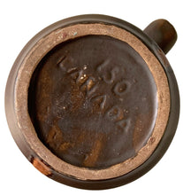 Load image into Gallery viewer, Base view of vintage brown with amber swirls glazed stoneware stein or mug. Showing maker's mark of Laurentian Pottery, Canada, 1970s
