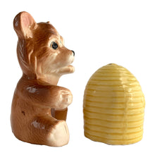 Load image into Gallery viewer, Vintage brown bear hugging a beehive ceramic salt and pepper shakers with plastic stoppers. Japan, 1970s. Add these adorable kitschy shakers to your collection!

In excellent condition, no chips/cracks/repairs. Marked Japan.

Bear measures 3 1/4 x 2 1/2 x 4 5/8 inches

Beehive measures 2 1/4 x 2 7/8 inches
