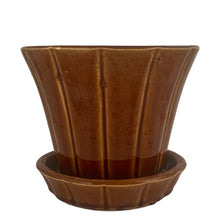 Load image into Gallery viewer, Striking vintage gloss brown Series 116 ribbed planter pot with attached saucer. Crafted by McCoy Pottery, 1940s. This rare planter is must for any McCoy art pottery collector!

In good vintage condition, flea bite at rim, hard water residue. Maker&#39;s mark on the bottom.

Measures 6 x 5 inches
