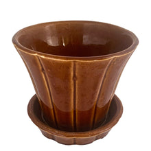 Load image into Gallery viewer, Striking vintage gloss brown Series 116 ribbed planter pot with attached saucer. Crafted by McCoy Pottery, 1940s. This rare planter is must for any McCoy art pottery collector!

In good vintage condition, flea bite at rim, hard water residue. Maker&#39;s mark on the bottom.

Measures 6 x 5 inches
