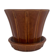 Load image into Gallery viewer, Striking vintage gloss brown Series 116 ribbed planter pot with attached saucer. Crafted by McCoy Pottery, 1940s. This rare planter is must for any McCoy art pottery collector!

In good vintage condition, flea bite at rim, hard water residue. Maker&#39;s mark on the bottom.

Measures 6 x 5 inches
