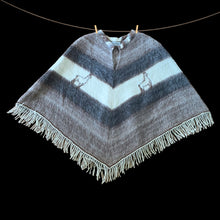 Load image into Gallery viewer, Charming vintage Boho-inspired split v-neck poncho, boasting a beautiful striped pattern in brown, mocha, and cream. The addition of a playful llama motif and fringed hem adds a touch of whimsy. This poncho is the perfect blend of style and comfort crafted from 50% llama/alpaca and 50% Merino wool, crafted by Poncho Quiaqueño, Argentina. A fabulous fashion statement to stay warm on those chilly days.

In excellent vintage condition.

Measures 20 inches across the shoulders and 42 inches across the bottom.
