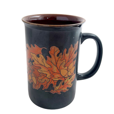 Vintage brown ceramic mug featuring oak leaves and acorns in ochre and honey, with ochreinterior. Design by Stanley Papel. Crafted by Otagiri, Japan, 1970s. A lovely mug to add to your collection.

In excellent condition, no chips or cracks.

Measures 5 x 3 1/2 x 5 inches

Capacity 12 ounces